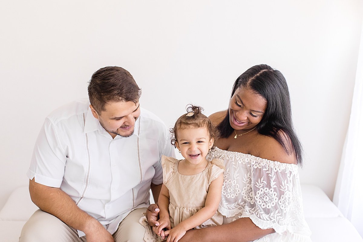 Family laughing together during maternity session with Ambre Williams Photography in Newport Beach Studio