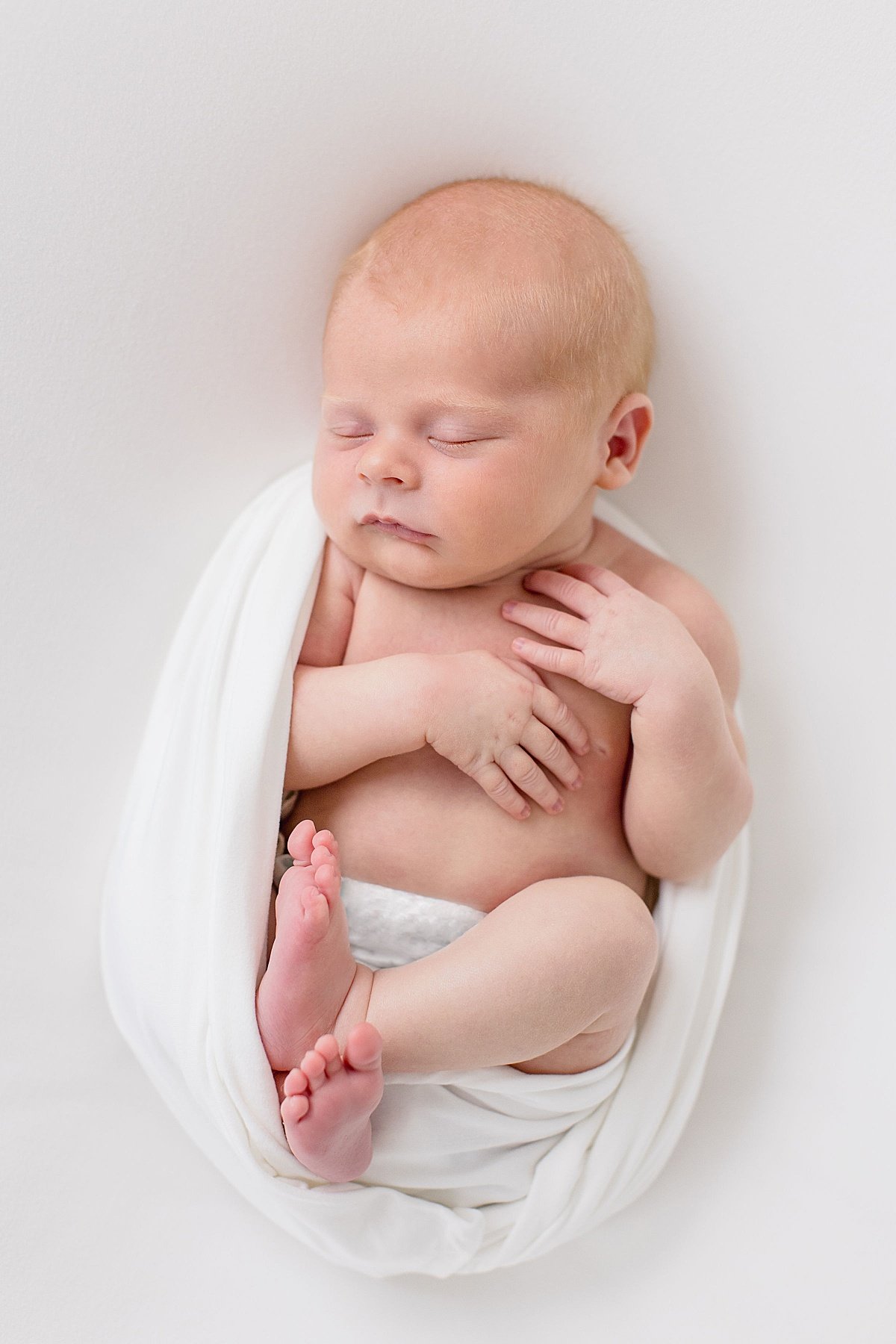 Newborn swaddled during Newborn Baby Session with photographer Ambre Williams in Newport Beach