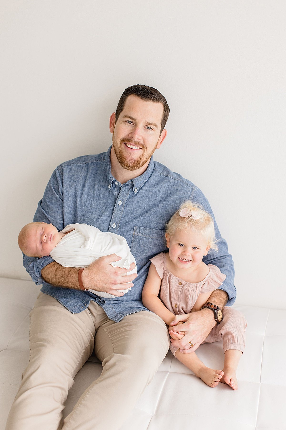 Dad with his newborn baby and oldest daughter during Newborn Studio Session with Newport Beach Photographer Ambre Williams