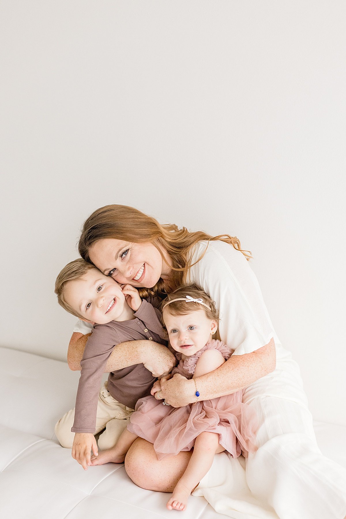 Candid Portrait of Mom holding her two children | Ambre WIlliams Photography in Newport Beach Studio