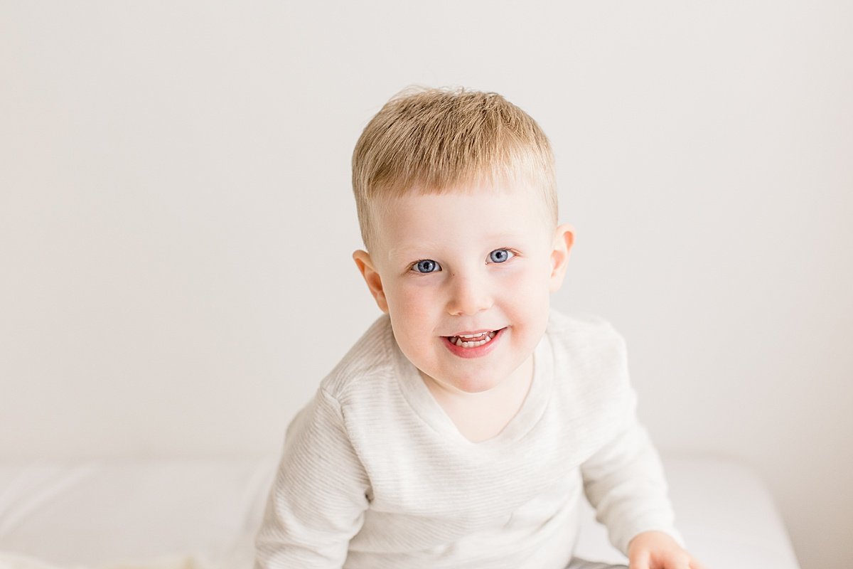 Young Son smiling at camera during Ambre Williams Photography Photo Session in Newport Beach