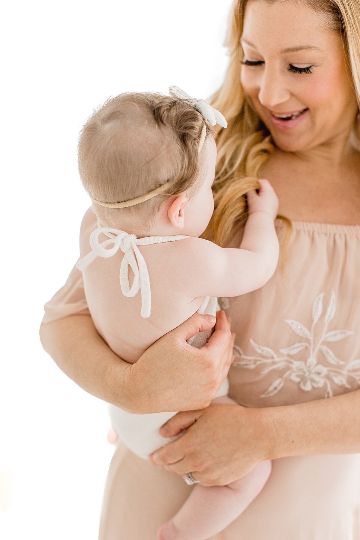 Mom and Young Daughter candid portrait during photo session in Newport Beach Studio with Ambre Williams Photography