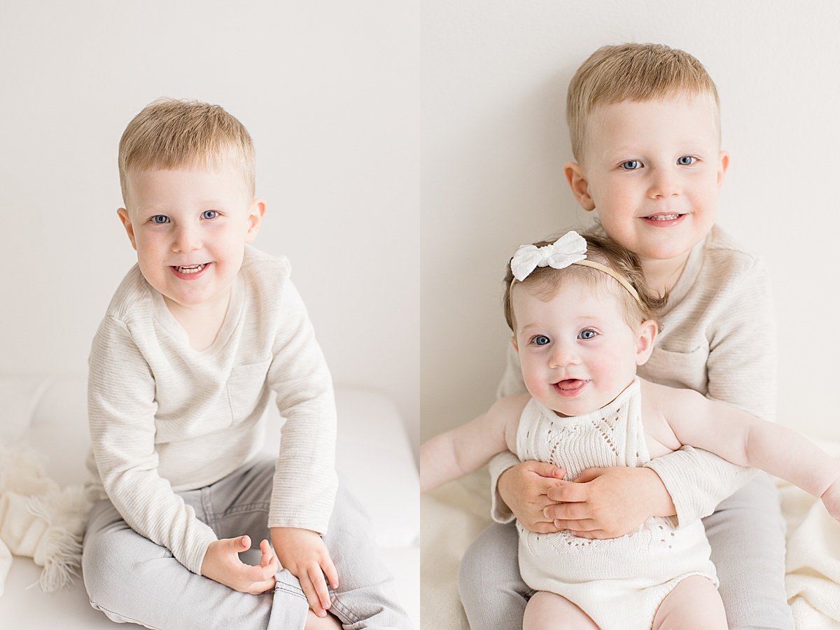 Big Brother holding little sister during 6-Month Portrait Session with Ambre Williams Photography