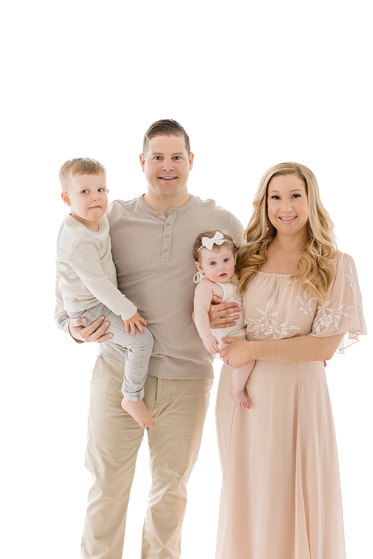 Family portrait session with Mom, Dad, and two children during six-month sitter milestone session | Newport Beach Photographer Ambre Williams