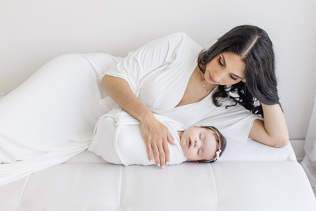 Beautiful Mama watching her sleepy newborn daughter | Ambre Williams Photography in Newport Beach California