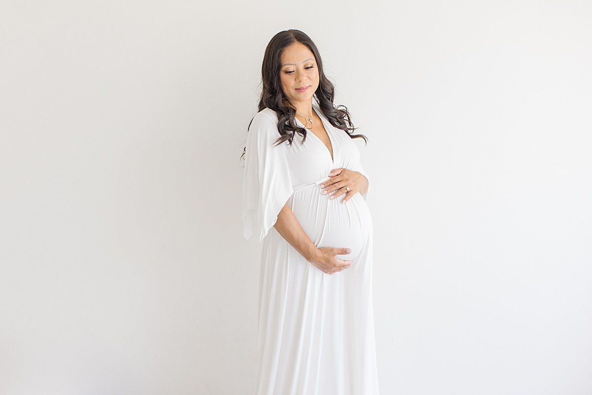 Mom-to-Be holding pregnant belly during maternity session | Newport Beach Studio Ambre Williams Photography
