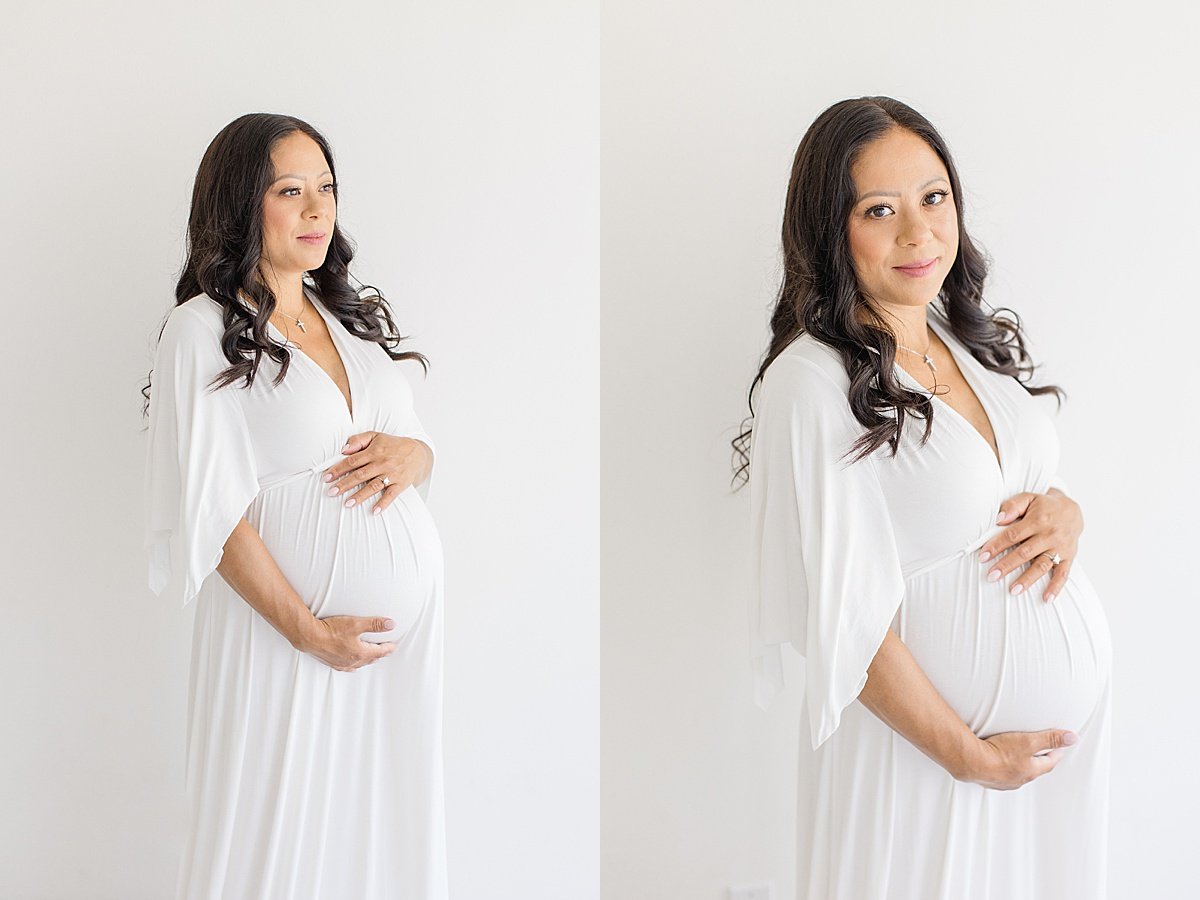 Pregnant mom holding belly during portrait studio with Ambre Williams Photography in Newport Beach