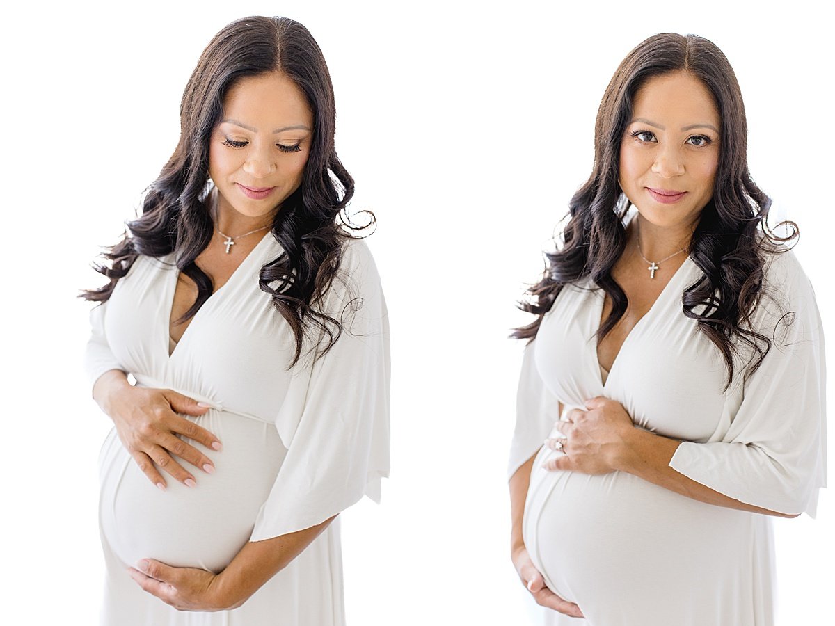 Mom wearing white dress holding pregnant belly during portrait session with Ambre Williams Photography in Newport Beach