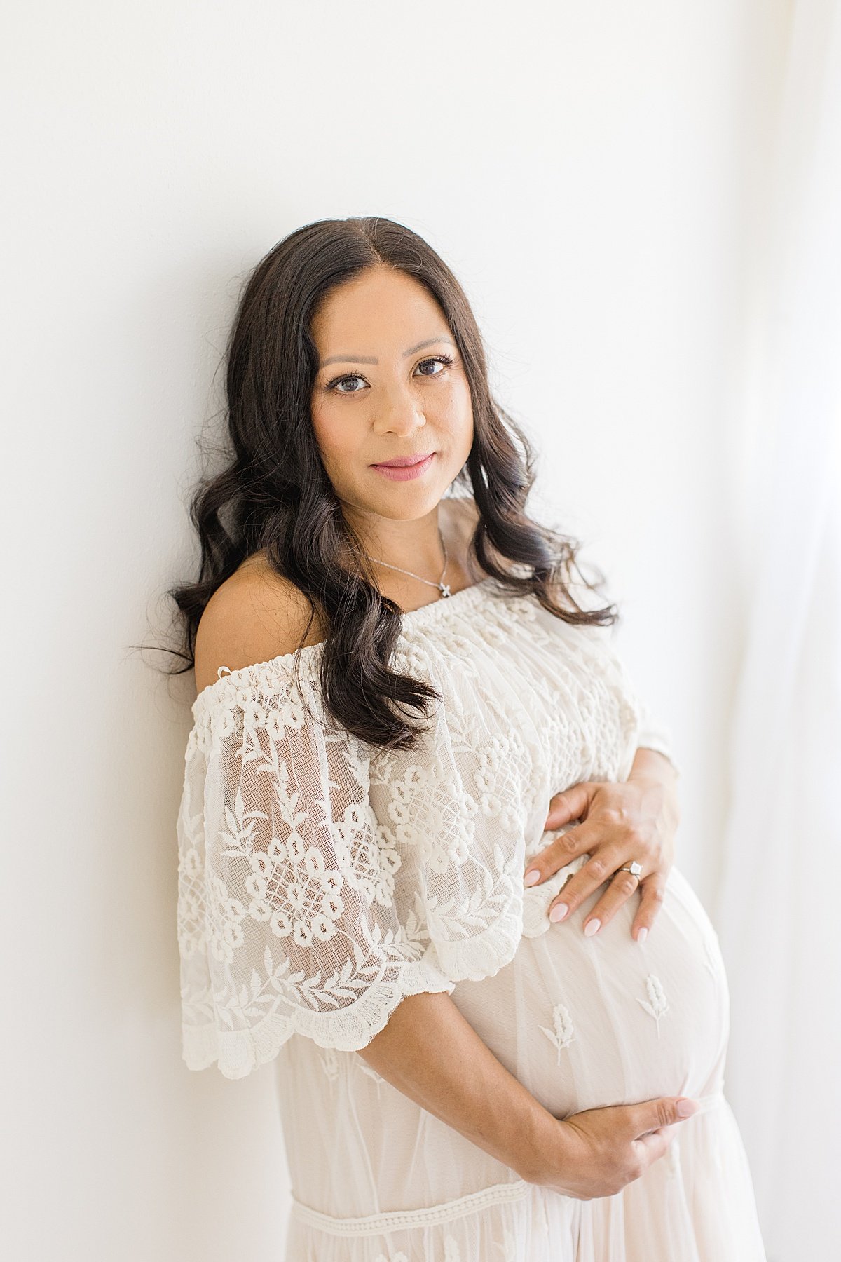 Beautiful Momma wearing lace dress during pregnancy portrait session with Ambre Williams Photography in Newport Beach