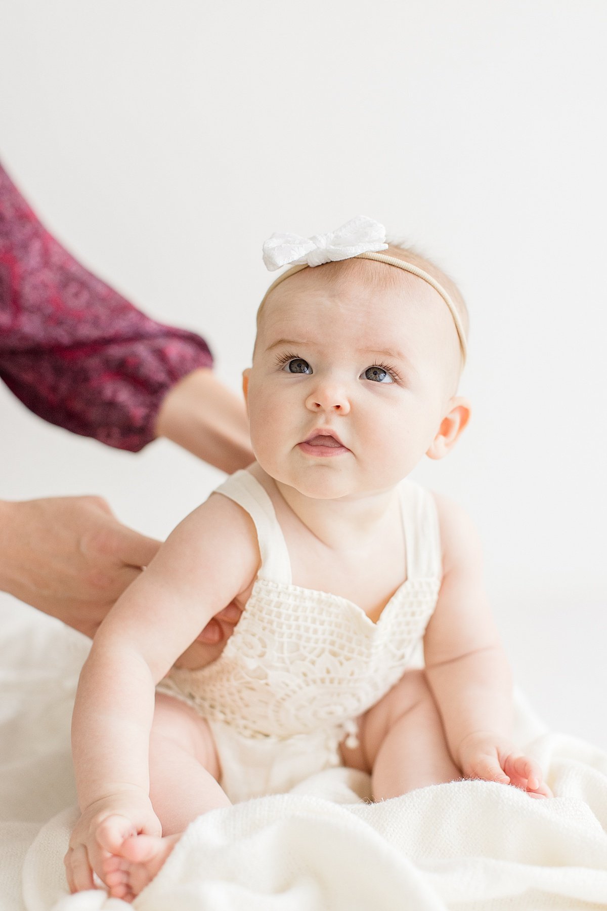 Baby looking up during photography portrait session with Ambre Williams Photography