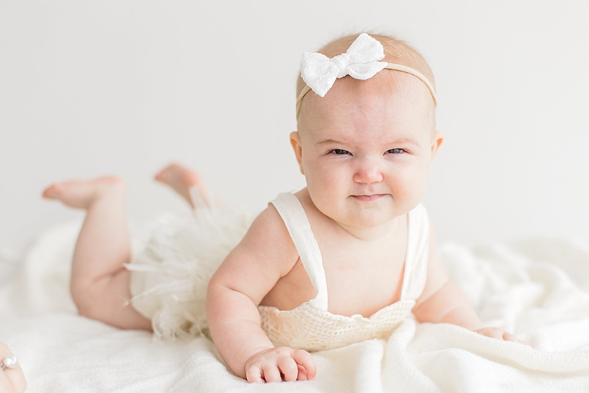 Smiling baby girl being silly during photography session with Ambre Williams in studio at Newport Beach in California