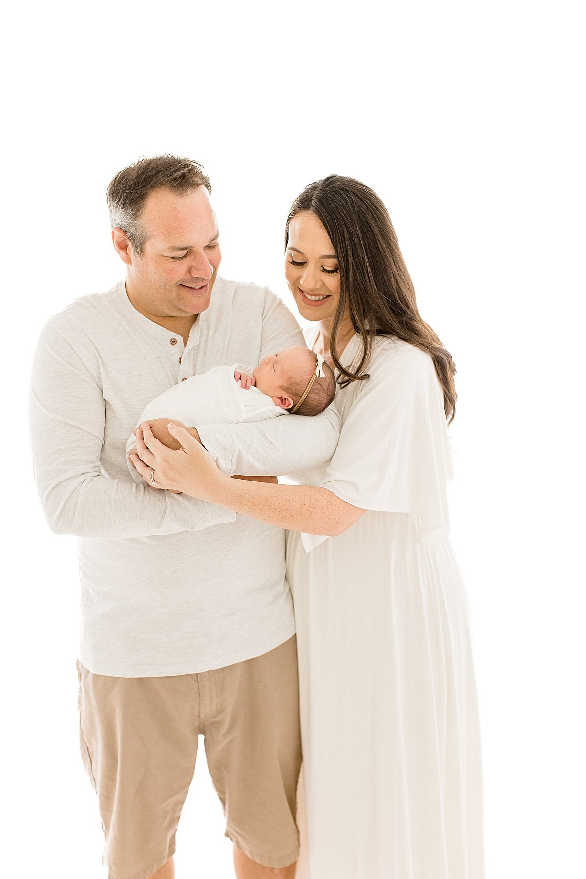Mom and Dad craddling newborn baby daughter | Newport Beach Photographer Ambre Williams 