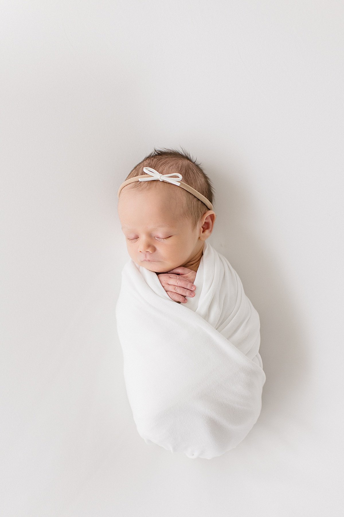 Sleepy newborn photography session in swaddle | Ambre Williams Photography in Newport Beach Studio