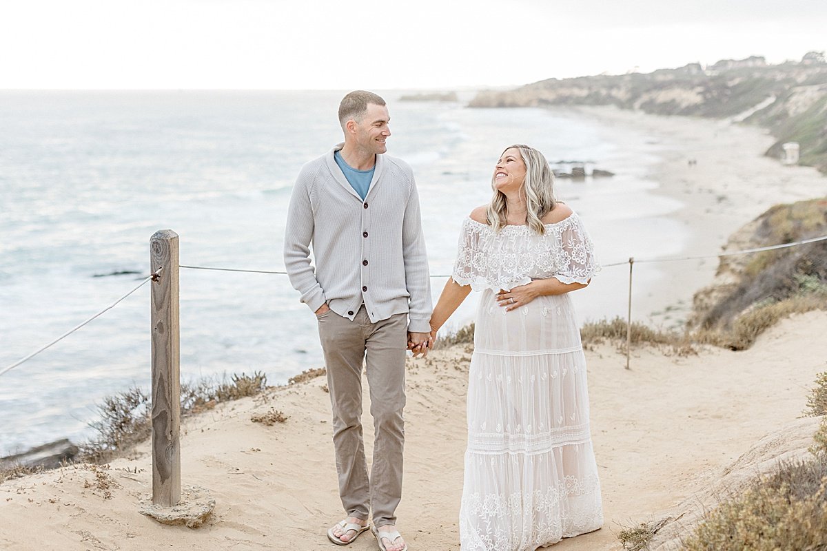 Candid Portrait of Husband and Wife during maternity session with Ambre Williams Photography | Newport Beach, California