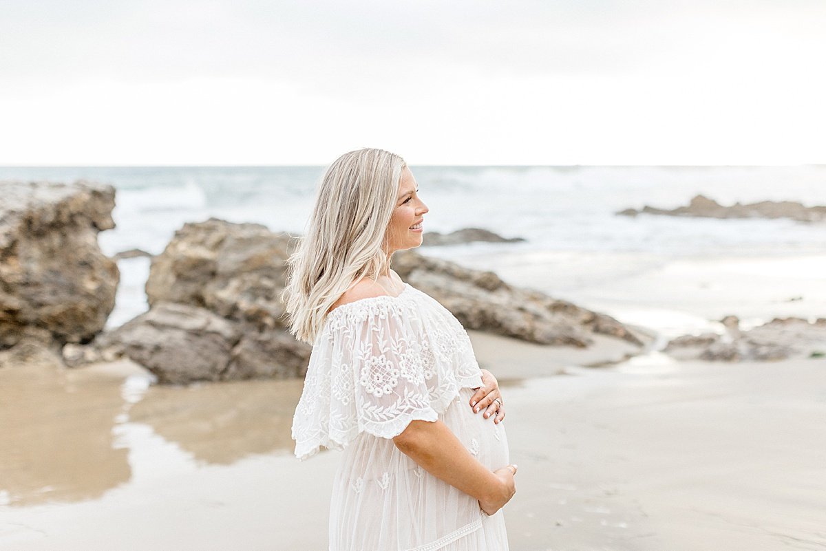 Mom-to-Be holding pregnant belly during outdoor portrait session with Ambre Williams Photography