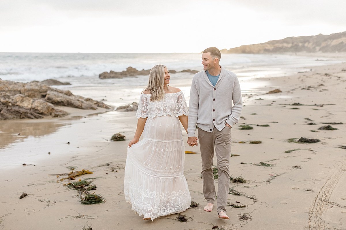 Candid Husband and Wife walking on beach | Ambre Williams Photography in Newport Beach California