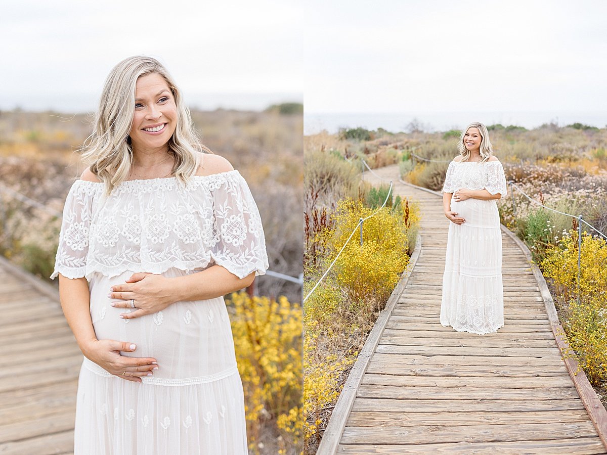 candid portrait of beautiful mom holding pregnant belly during maternity portrait session with Ambre Williams on Newport Beach in California