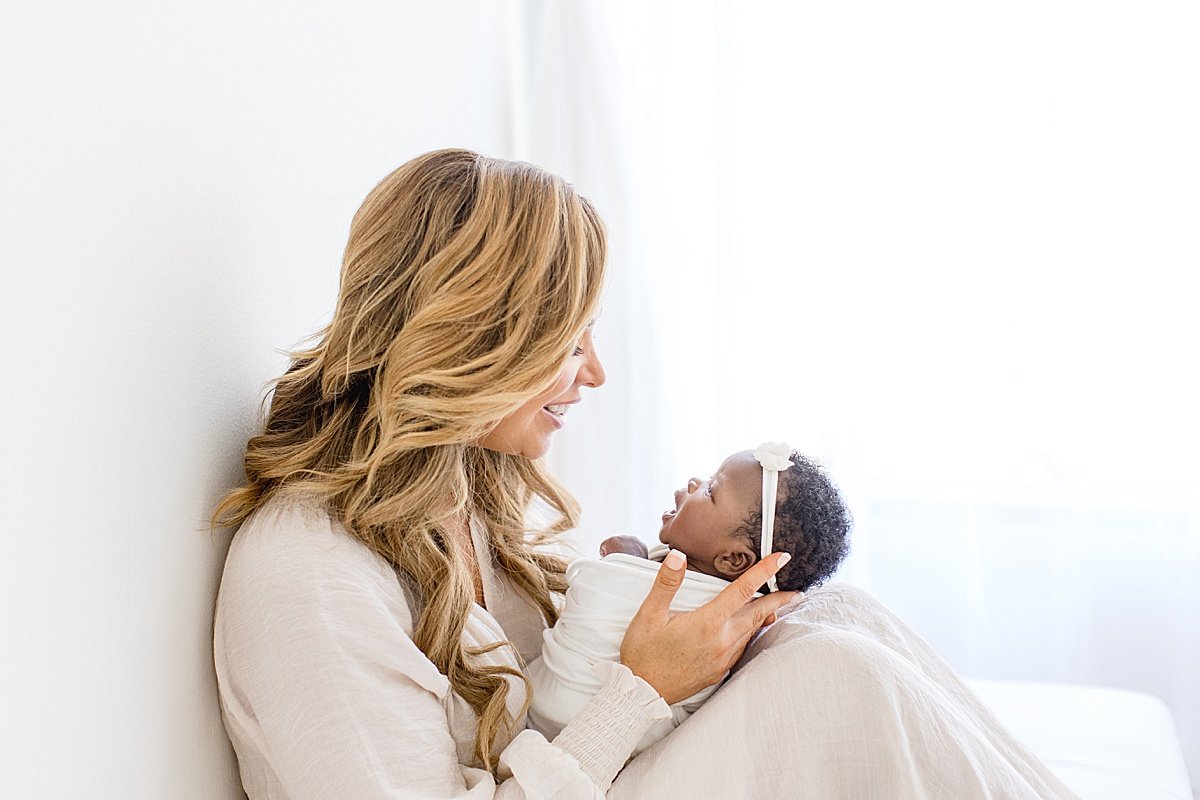 Beautiful Mama holding newborn daughter | Ambre Williams Photography located in California