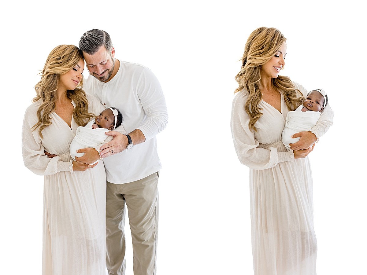 Mom and Dad holding newborn baby daughter lovingly | Newport Beach California Photographer Ambre Williams in Studio
