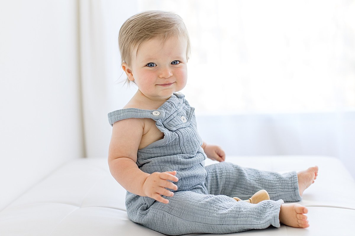 Happy baby boy smiling at camera during studio portrait session with Ambre Williams Photography