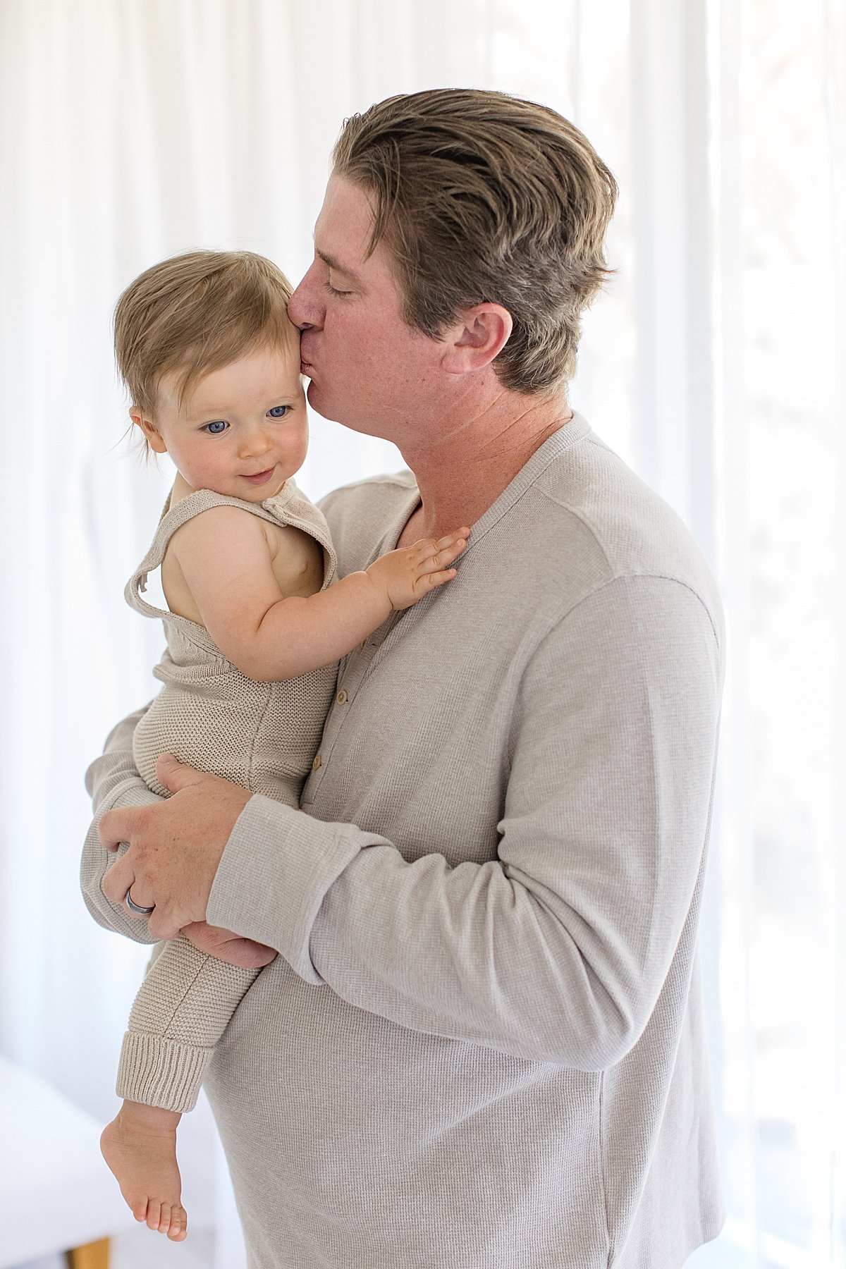 Dad kissing his son during his first birthday photo session | Newport Beach Photographer Ambre Williams