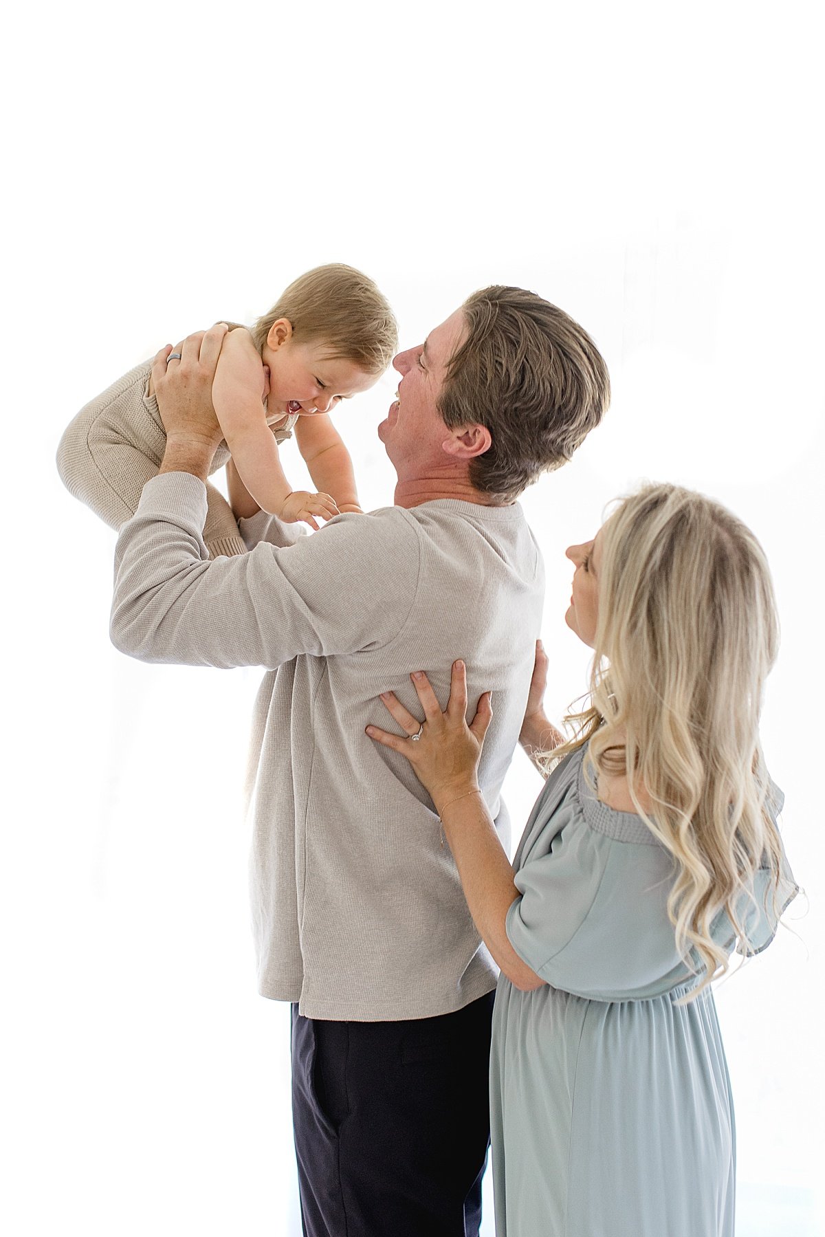 Ambre Williams Photographs couple and their one year old baby during a studio milestone session in Newport Beach, California