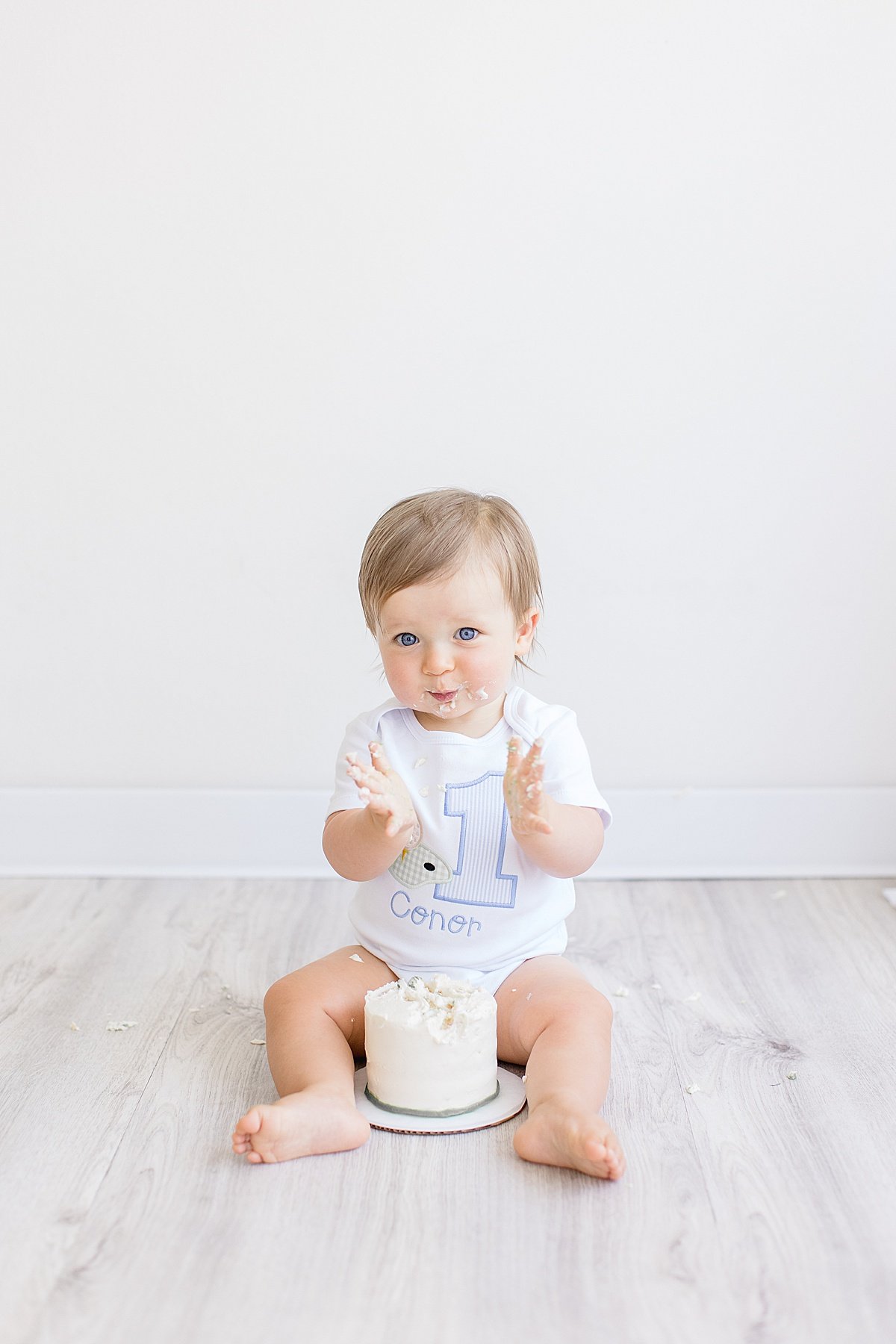 Happy baby smiling with first smash cake | Newport Photographer Ambre WIlliams in Studio