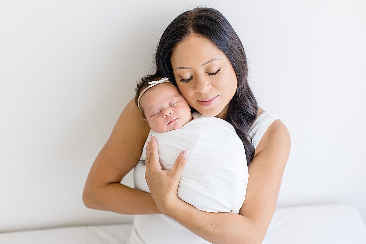 Ambre Williams Photography takes portraits of newborn baby daughter with beautiful mama in studio at Newport Beach