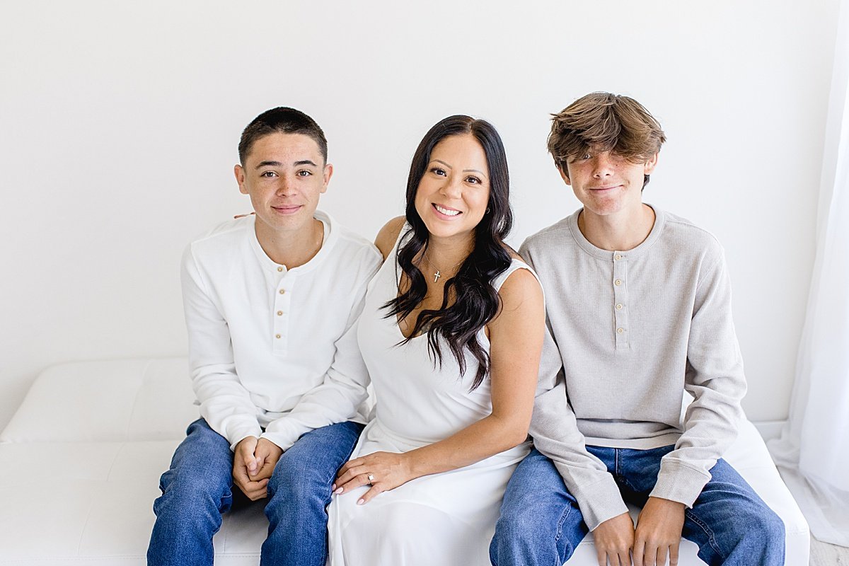 Happy Mom with her two oldest sons during portrait session in Newport Beach with Ambre Williams Photography