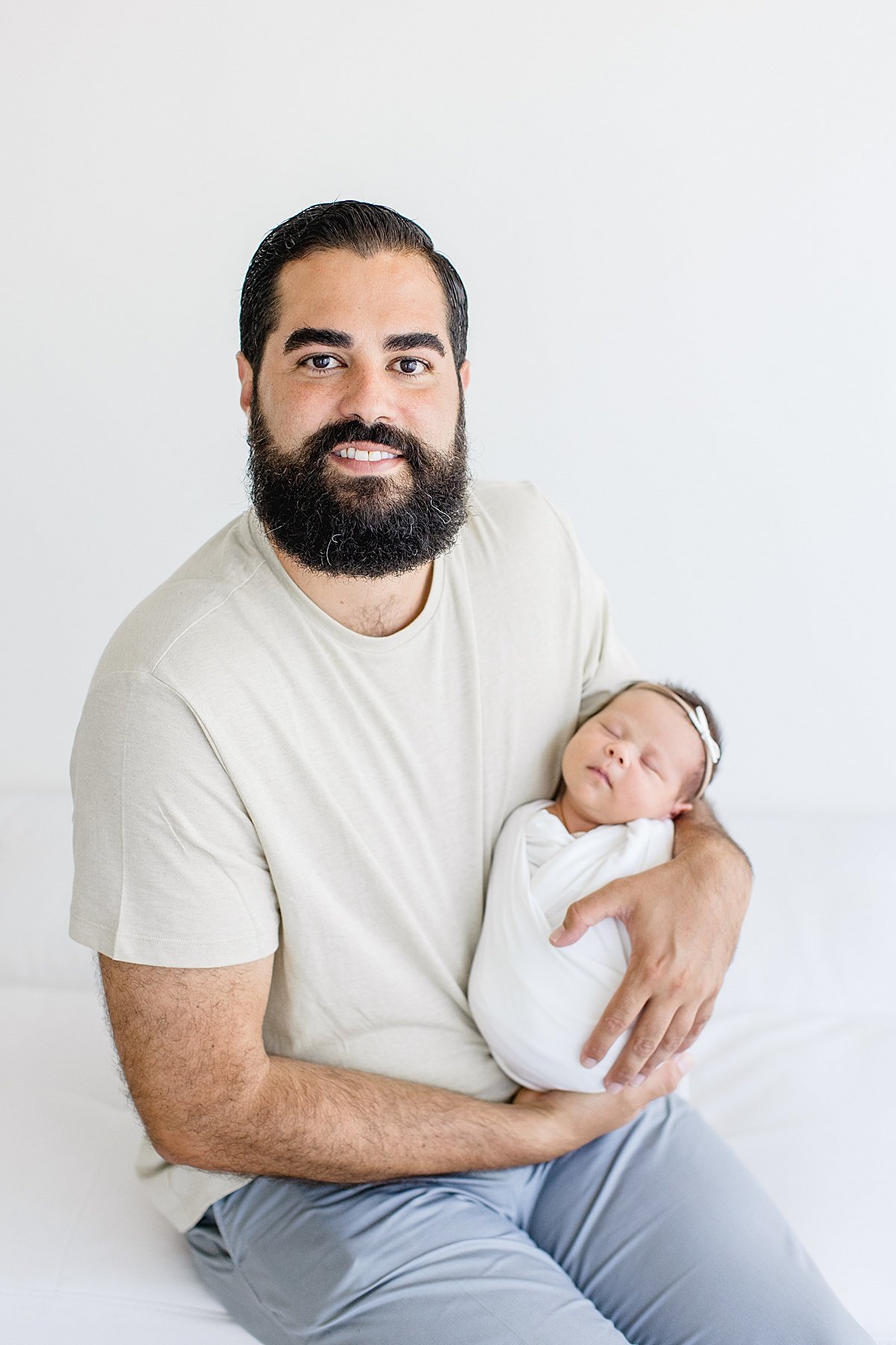 Happy Dad smiling with little newborn daughter | Newport Beach Photographer Ambre Williams in studio