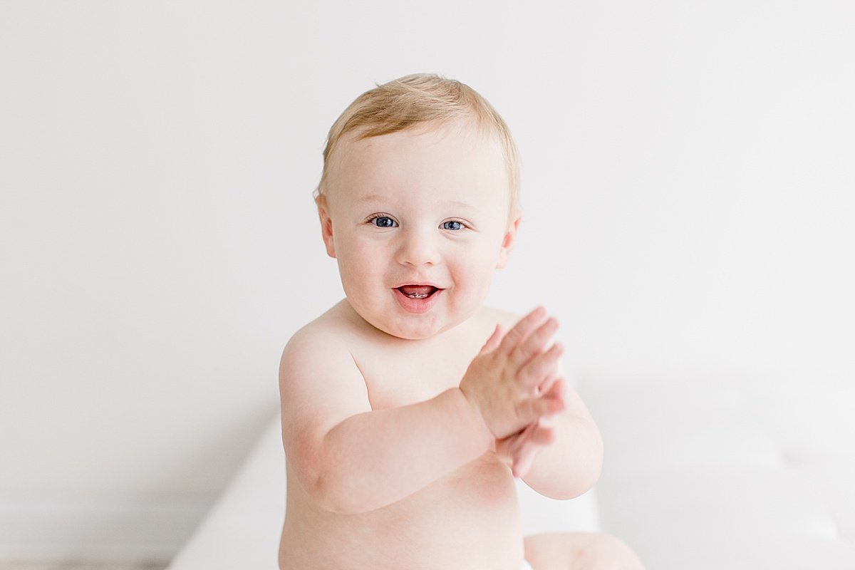 Happy boy clapping during photography session with Ambre Williams in her studio at Newport Beach