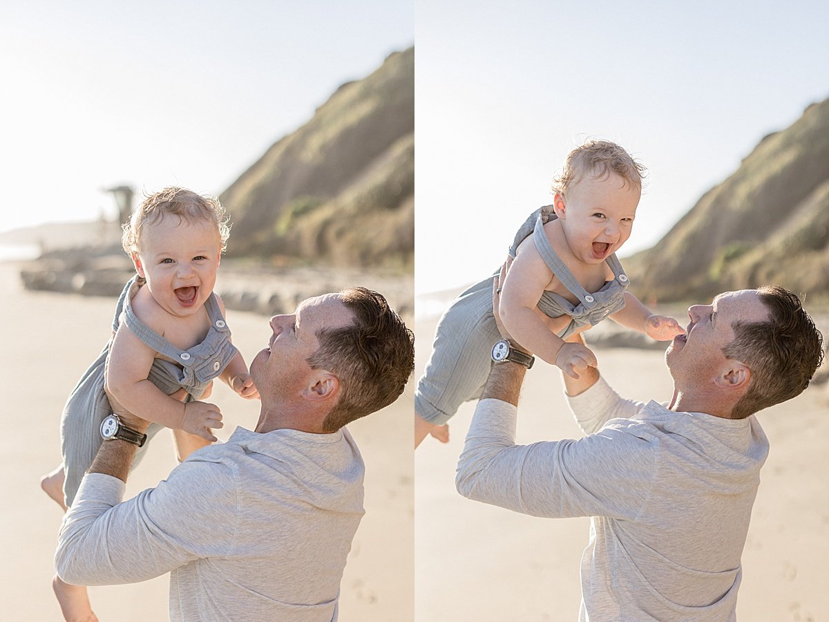 Candid photos of happy dad holding his son up during sunset beach session with Ambre Williams Photography