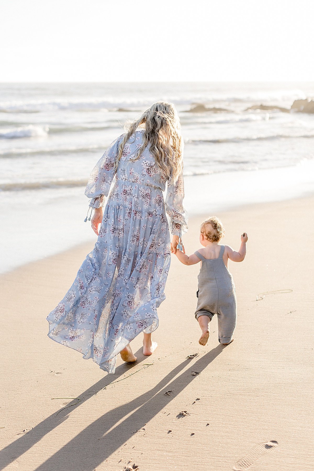 Candid portraits of Mom running with Baby boy in bad at beach session during sunset | Ambre Williams Photography in California