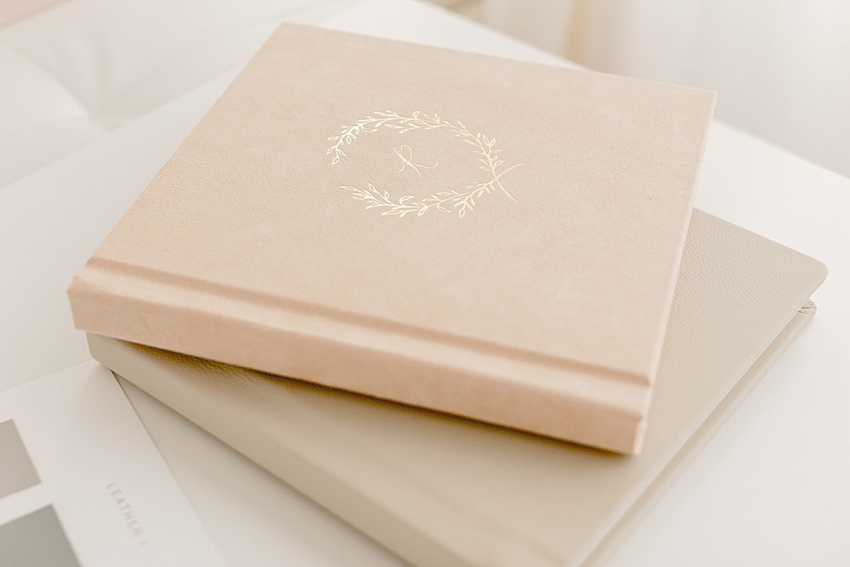 2 Heirloom family photography albums on table with gold embossing | Ambre Williams Photography in Newport Beach California