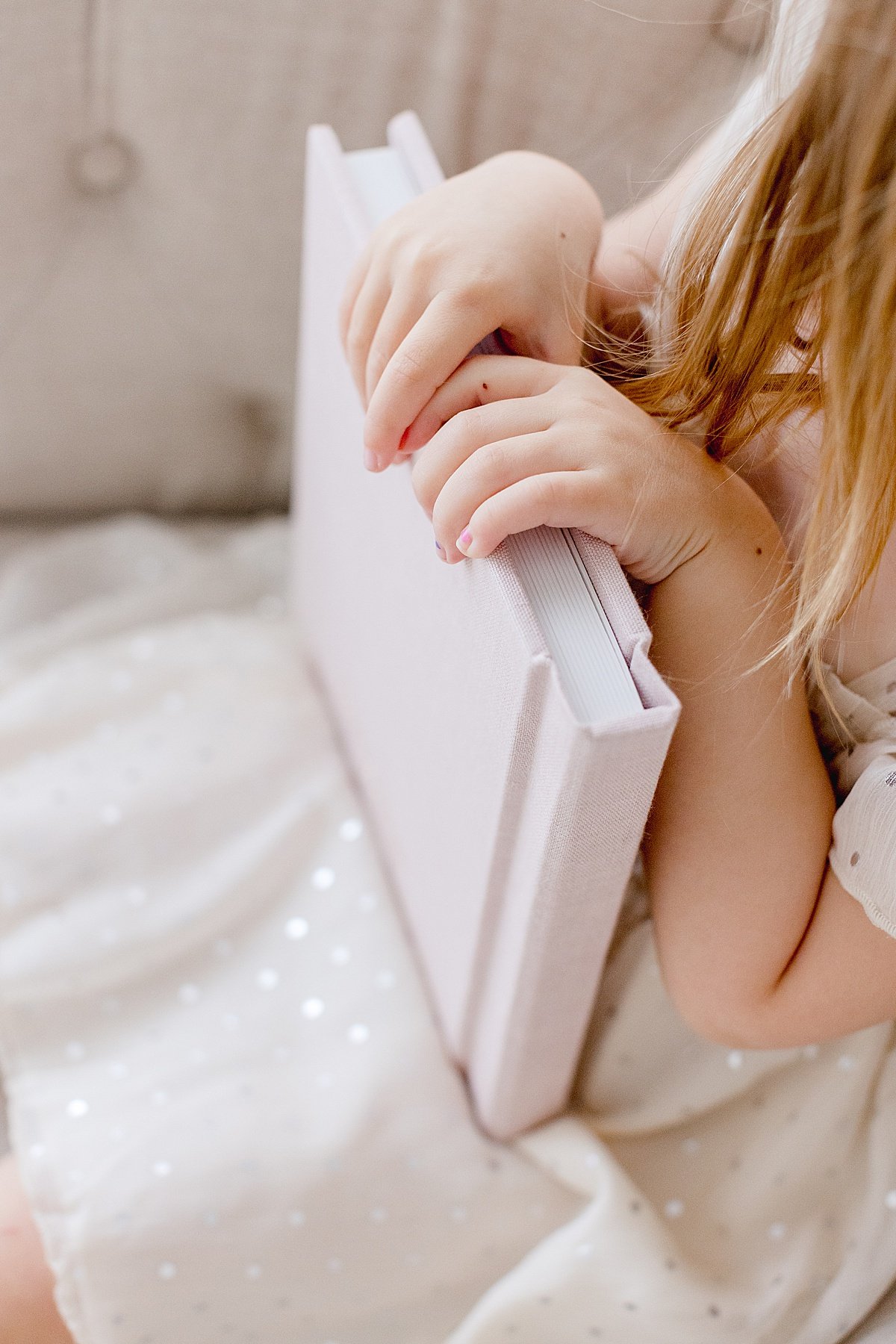 Little Child holds her family heirloom book in a glittery white dress | Ambre Williams Photography Detail Photo