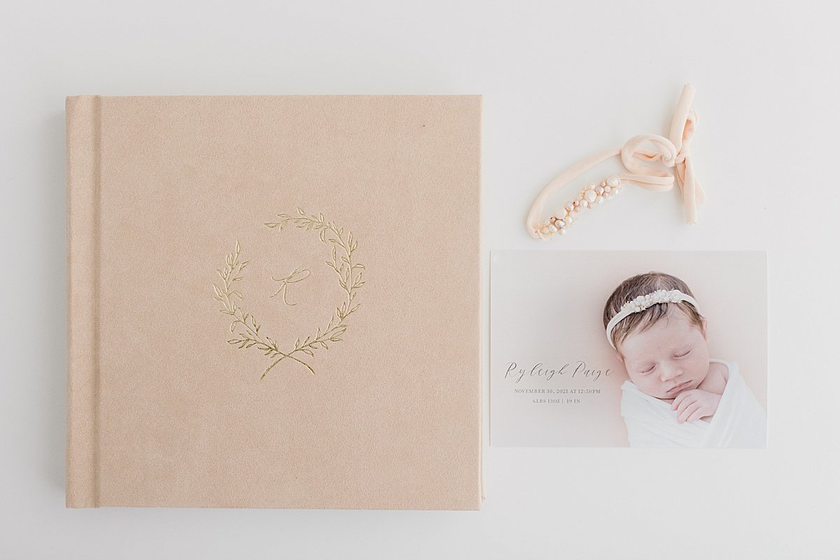 Ambre Williams Photography offers Pink Heirloom Family Photo Album Flay Lay with Baby Announcement and Baby Hair Bow