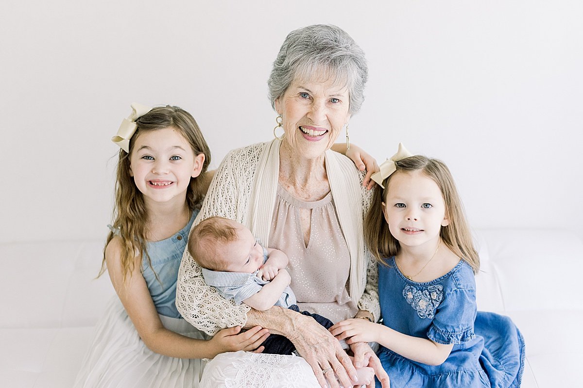 Great-Grandmother and grandchildren smiling together during portrait studio session with Ambre Williams Photography in Newport Beach CA