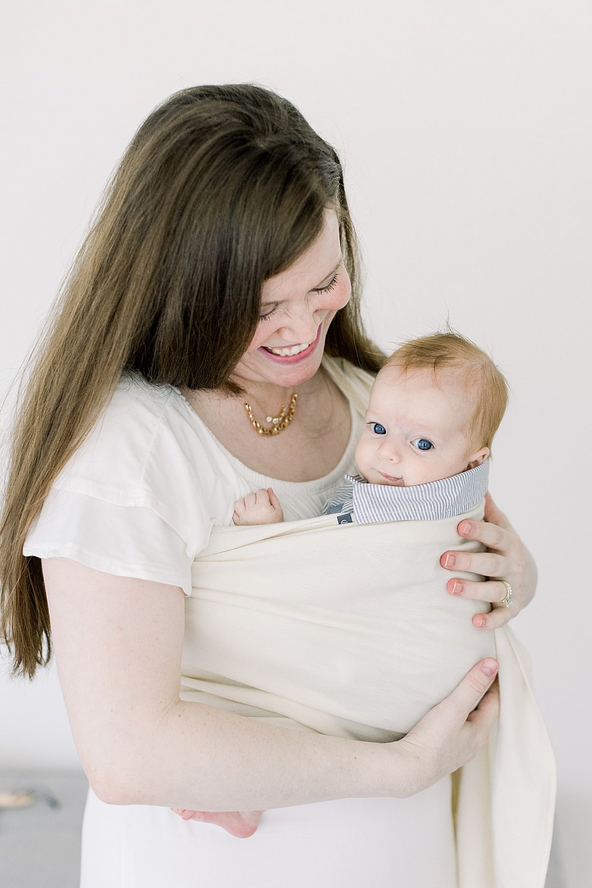 Mom smiling at little baby son during portrait session with grandparents | Newport Beach Photographer Ambre Williams