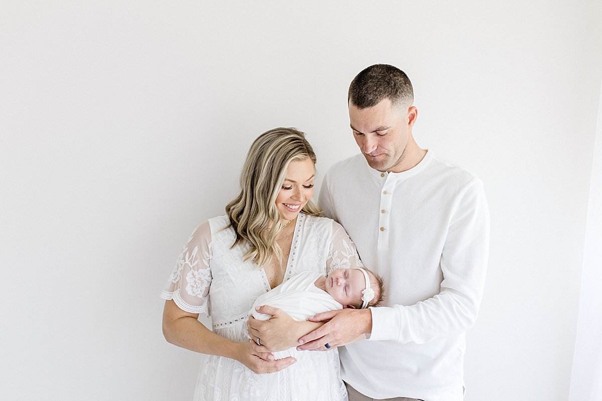 Mom and Dad welcome baby girl in newborn portrait session with Ambre Williams Photography in Newport Beach