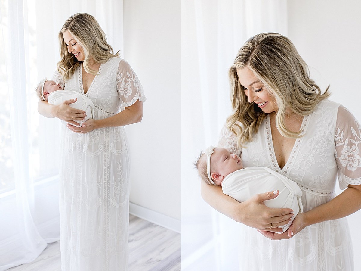 Happy Momma holding her baby girl during portrait session with Ambre Williams Photography in Newport Beach California