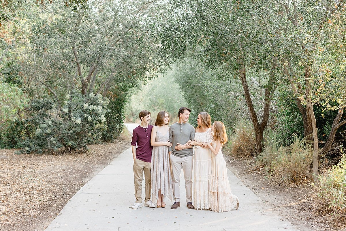 family posing together in the wooded street area with Ambre Williams Photography