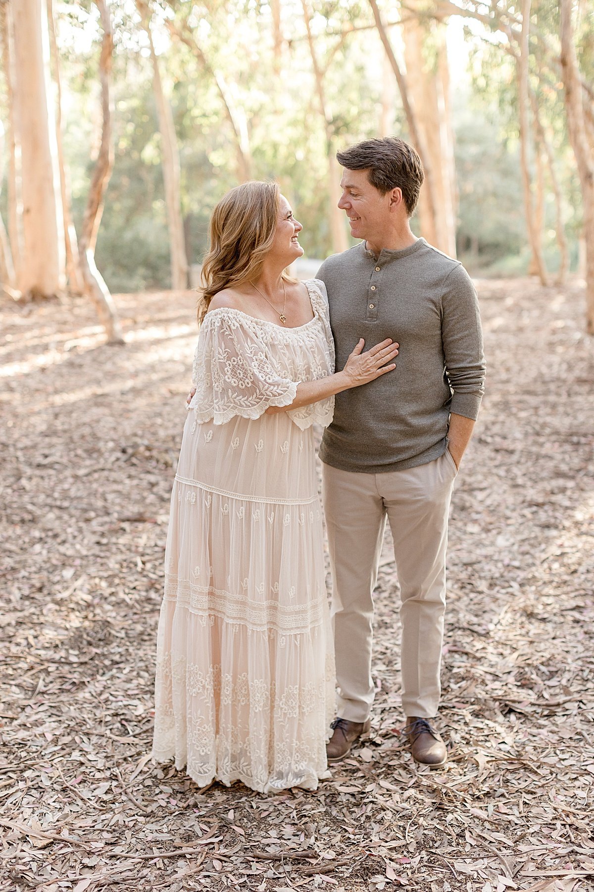 mom and dad smiling at each other during candid moment with Ambre Williams Photography