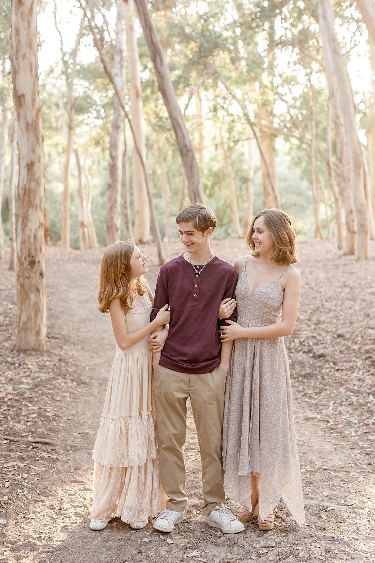 Siblings laughing together smiling during outdoor photography portrait session with Ambre Williams Photography