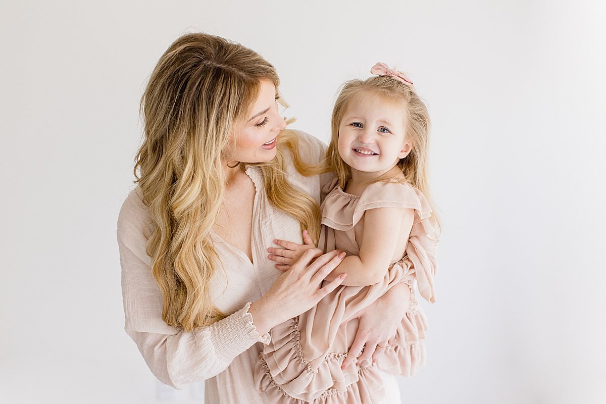 Mom and daughter smiling during portrait session with Ambre Williams Photography in Newport Beach California 