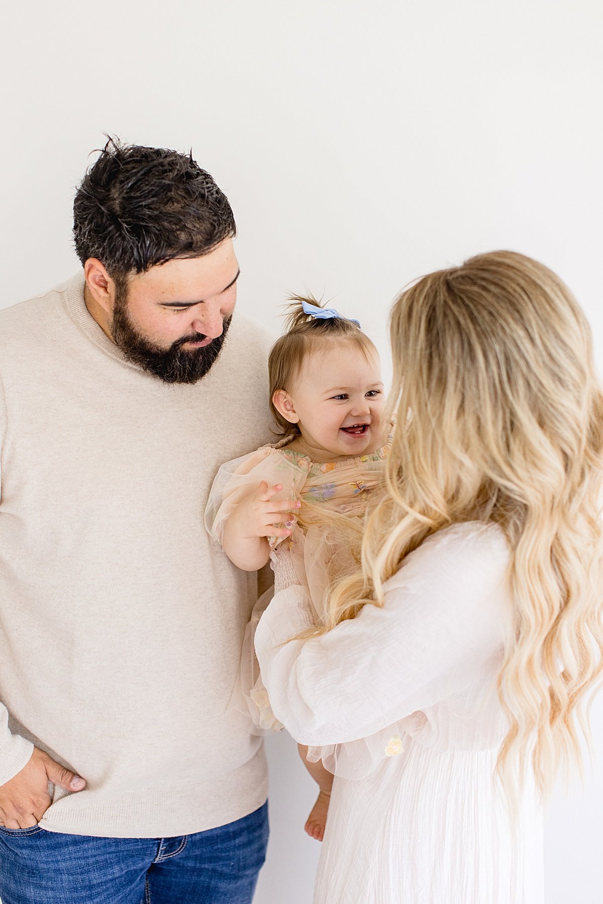 Parents and little daughter smiling candid portrait of family | Ambre WIlliams Photography