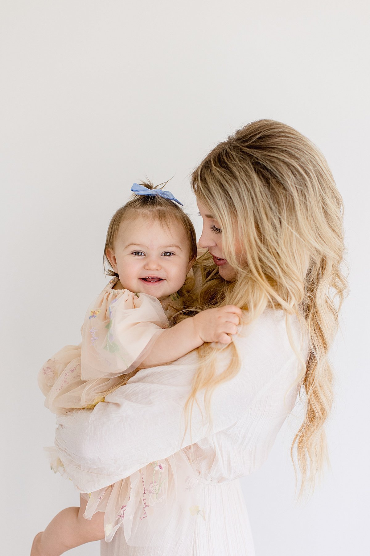 Mom and Baby daughter smiling and laughing during portrait session with Ambre Williams Photography in Newport Beach California