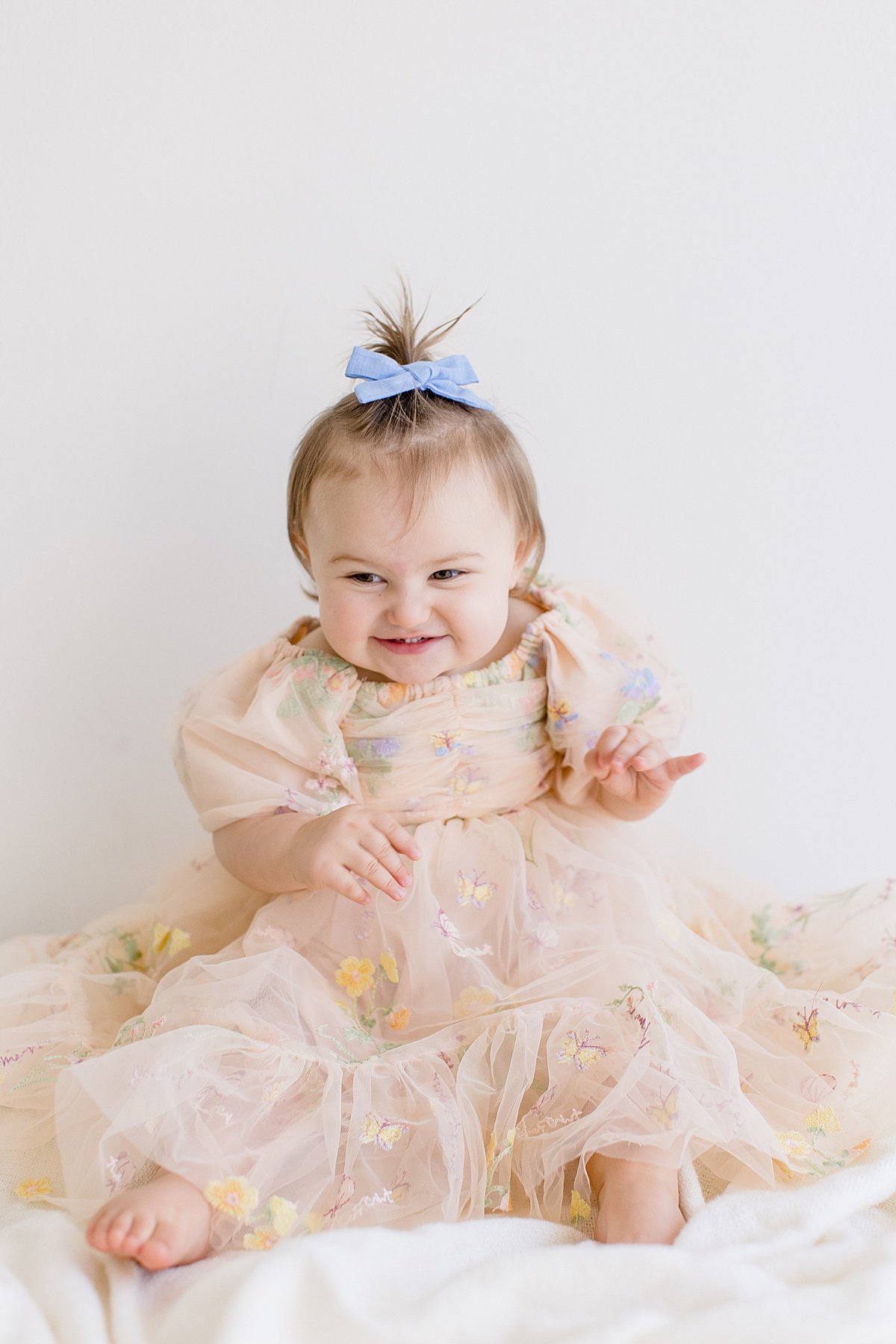 Happy smiling one year old girl during portrait session with Ambre Williams Photography in Newport Beach studio