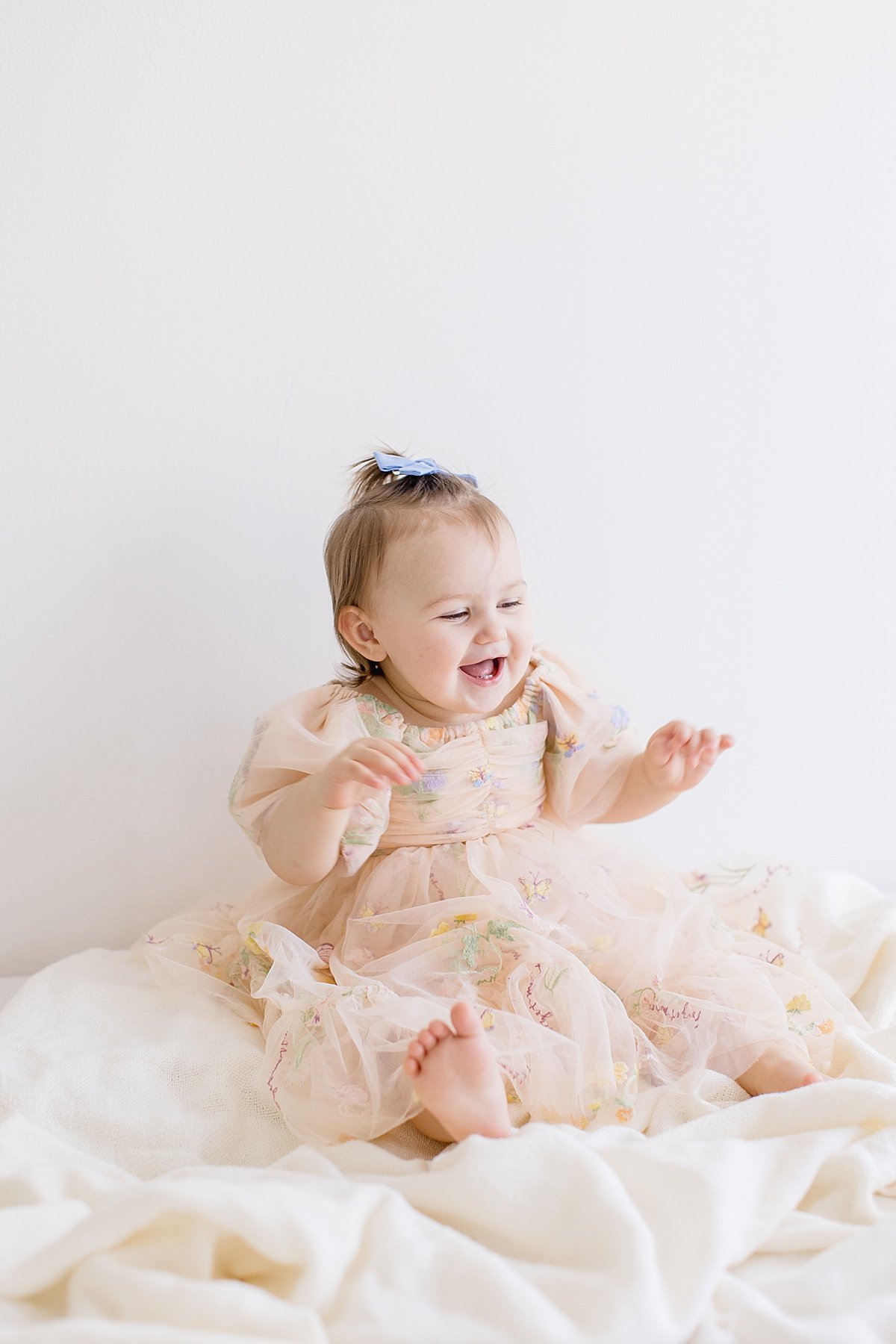 Ambre Williams Photography in Newport Beach take studio picture of one year old girl during smash cake session