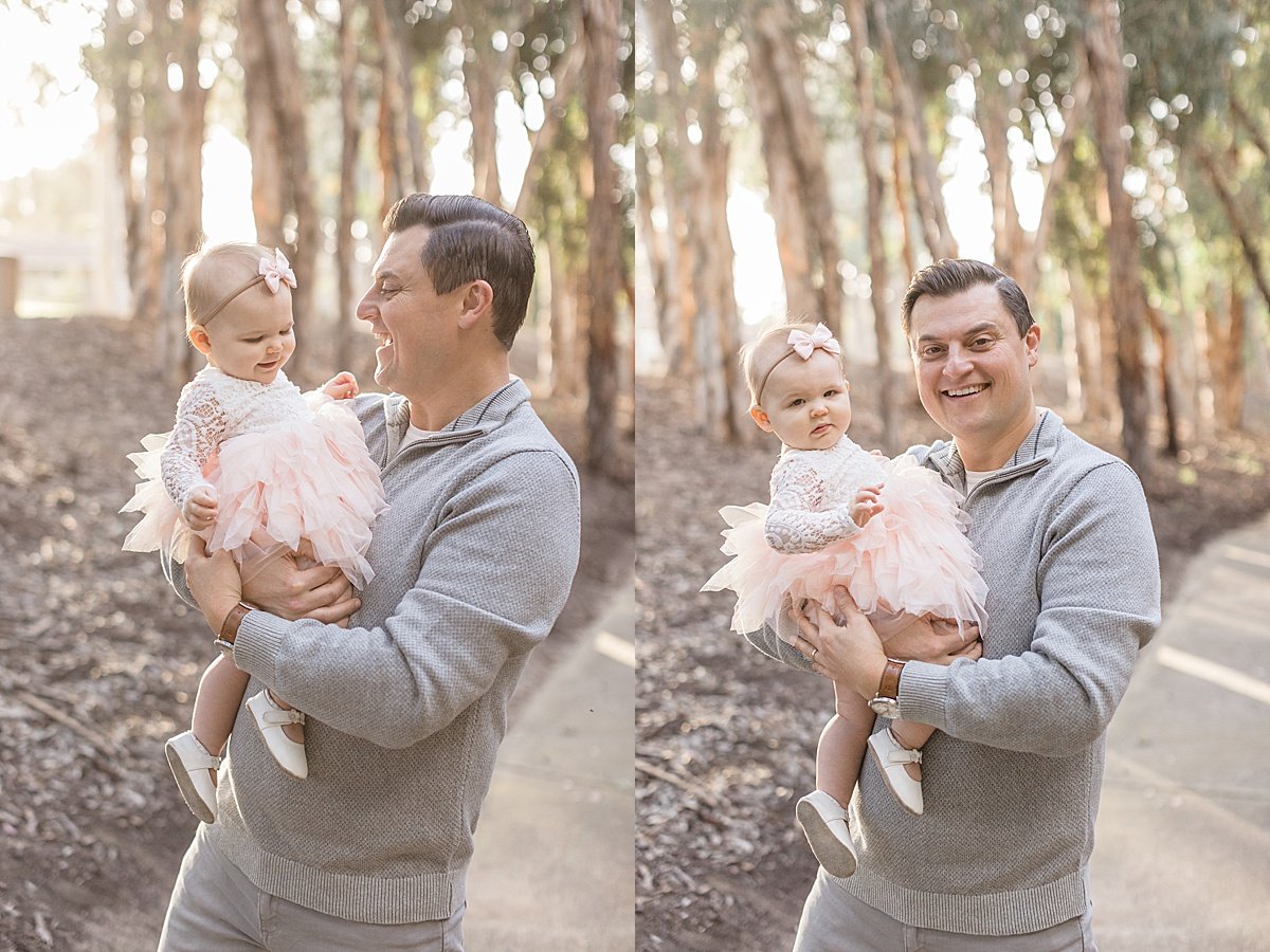 Happy Smiling Baby Daughter playing with dad during outdoor fall session with Ambre Williams Photography