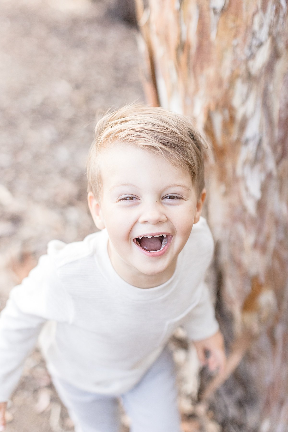 Happy smiling son candid portrait during outdoor family session with Ambre Williams Photography